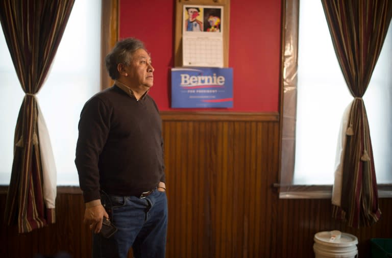 Present Captain of the local caucus Jose Zaharias stands in his living room near a Democratic Presidential Candidate Bernie Sanders placard in West Liberty, Iowa, January 25, 2016, ahead of the Iowa Caucus
