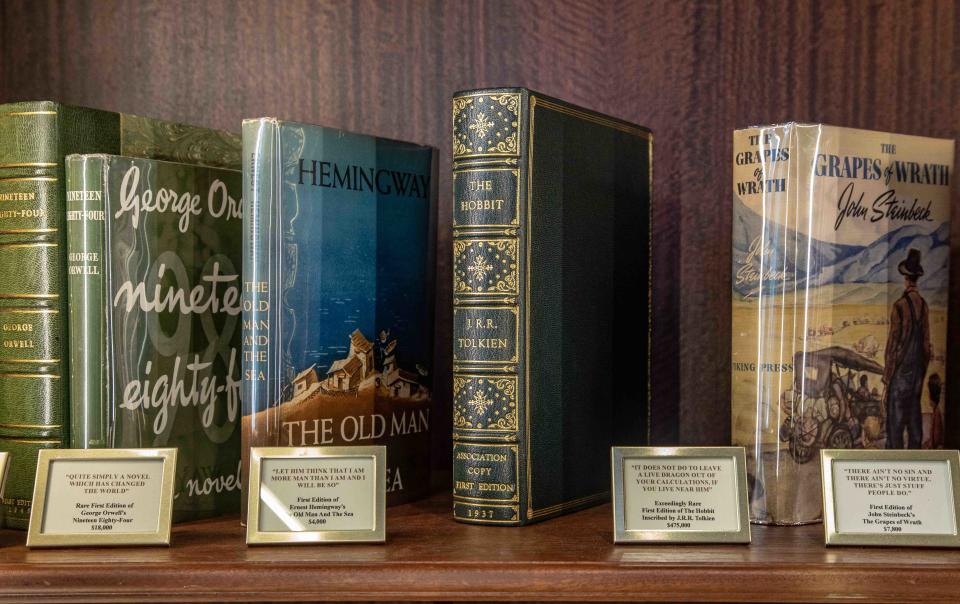 A rare, first issue presentation copy of J.R.R. Tolkien's "The Hobbit" (center), for sale at Raptis Rare Books in Palm Beach, Florida, on Nov. 15, 2022.