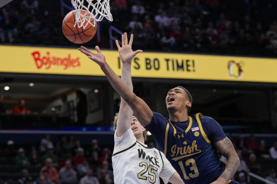 Notre Dame forward Tae Davis (13) shoots in front of Wake Forest forward Zach Keller (25) during the second half of the Atlantic Coast Conference second round NCAA college basketball tournament game Wednesday, March 13, 2024, in Washington. (AP Photo/Susan Walsh)