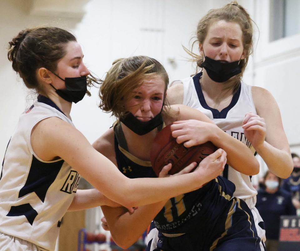 East Bridgewater's Allie Pechulis,  is surrounded by Rockland defenders from left, Sydney Blaney and Maddie Hermenau during a game on Tuesday, Jan. 18, 2022.