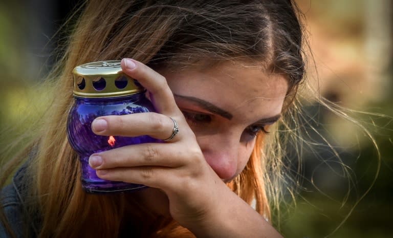 Tearful victims brought candles for the dead