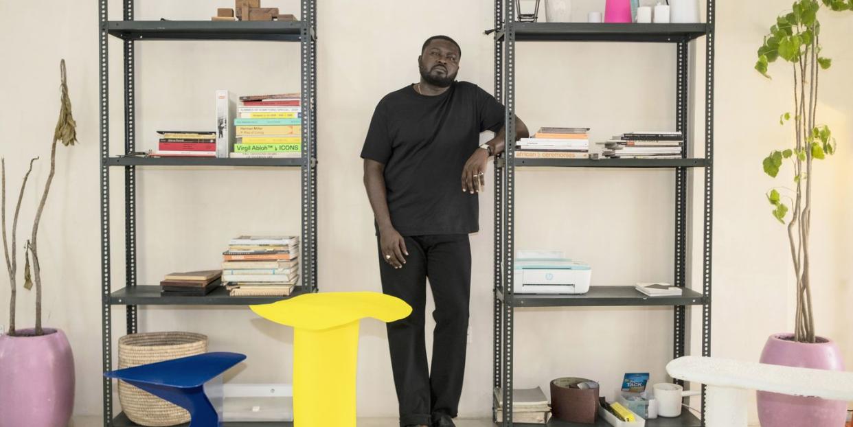 a man standing in front of a book shelf