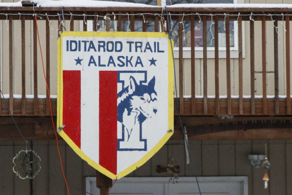 An Iditarod trail poster is shown Monday, Feb. 26, 2024, hanging outside a home in Knik, Alaska. The Iditarod Trail Sled Dog Race begins Saturday, March 2, in Anchorage, Alaska. (AP Photo/Mark Thiessen)