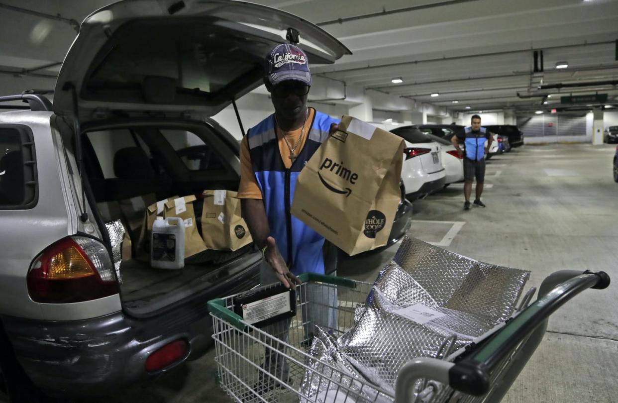 <span class="caption">Samuel Diaz, a delivery worker for Amazon Prime, loads his vehicle with groceries from Whole Foods in Miami.</span> <span class="attribution"><span class="source">AP Photo/Lynne Sladky</span></span>