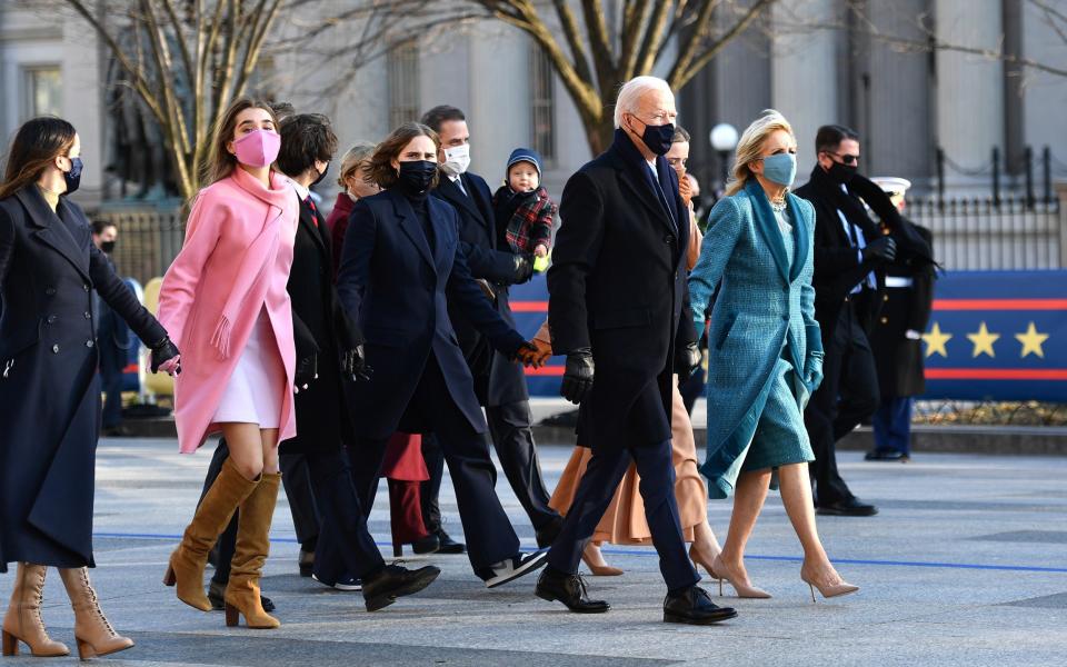 Joe Biden leads his family along the parade route in DC - GETTY IMAGES