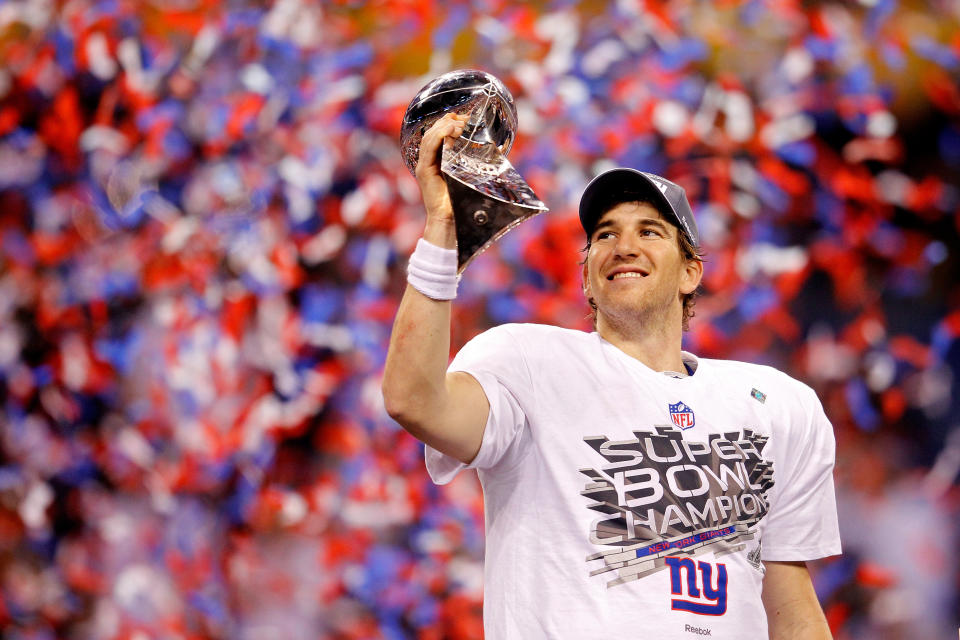 Quarterback Eli Manning #10 of the New York Giants poses with the Vince Lombardi Trophy after the Giants defeated the Patriots by a score of 21-17 in Super Bowl XLVI at Lucas Oil Stadium on February 5, 2012 in Indianapolis, Indiana.