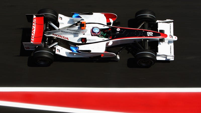 A photo of the red, white and black Super Aguri F1 car on track in Spain. 