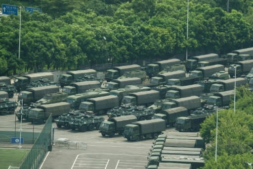 Trucks and armoured personnel carriers are seen outside the Bay stadium in Shenzhen, which borders Hong Kong