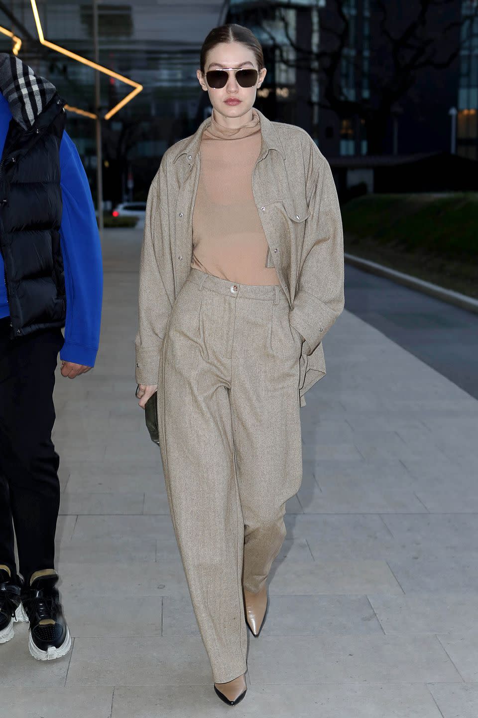 <p>In a sheer, beige turtleneck, matching neutral button-up and slacks, the <a href="https://shop.wandler.com/products/bente-ankle-boot-khaki-black" rel="nofollow noopener" target="_blank" data-ylk="slk:Bente Ankle Boot by Wandler;elm:context_link;itc:0;sec:content-canvas" class="link ">Bente Ankle Boot by Wandler</a>, and black shades.</p>