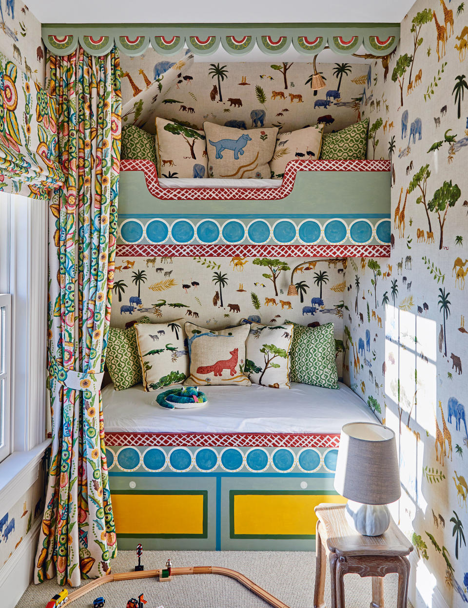 Small kitchens room with loft bed and animal-print wallpaper