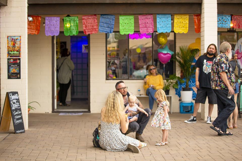 Customers gather outside during the grand opening of Eighty Seven in Phoenix on Nov. 20, 2021.