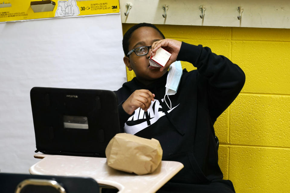 Carl Hall, 8, drinks apple juice he received as part of a free bagged breakfast at the Jefferson County Upper Elementary School on Wednesday, March 3, 2021 in Fayette, Miss. (AP Photo/Rogelio V. Solis)