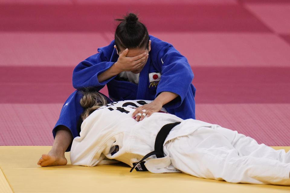 Funa Tonaki, top, of Japan, reacts after losing to Distria Krasniqi, of Kosovo, in their women's 48-kg judo gold medal match at the 2020 Summer Olympics, Saturday, July 24, 2021, in Tokyo. (AP Photo/Jae C. Hong)