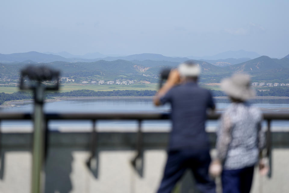 A visitor uses binoculars to see the North Korean side from the unification observatory in Paju, South Korea, Thursday, Sept. 8, 2022. South Korea's new government on Thursday proposed a meeting with North Korea to resume reunions of families separated since the 1950-53 Korean War, despite long-strained ties between the rivals over the North's nuclear weapons program. (AP Photo/Lee Jin-man)