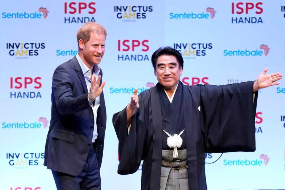 Prince Harry, escorted by Haruhisa Handa, CEO of the International Sports Promotion Society (ISPS), attends an event organized by the ISPS Wednesday, Aug. 9, 2023 (AP)