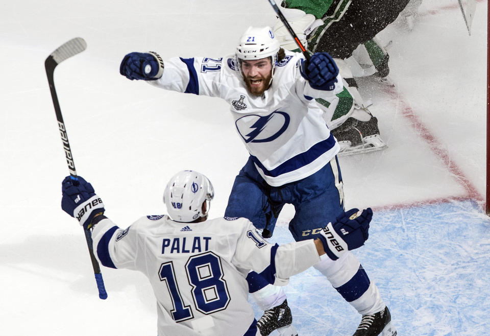 Tampa Bay Lightning center Brayden Point (21) celebrates his goal against the Dallas Stars with teammate Ondrej Palat (18) during the second period of Game 3 of the NHL hockey Stanley Cup Final, Wednesday, Sept. 23, 2020, in Edmonton, Alberta. (Jason Franson/The Canadian Press via AP)