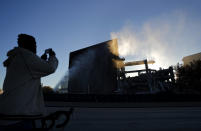 <p>Larry Jenkins takes a photo of the remains of the Georgia Dome after it was imploded in Atlanta, Monday, Nov. 20, 2017. The dome was not only the former home of the Atlanta Falcons but also the site of two Super Bowls, 1996 Olympics Games events and NCAA basketball tournaments among other major events. (AP Photo/David Goldman) </p>