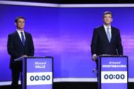 Former Prime minister Manuel Valls, left, and former Economy minister Arnaud Montebourg look on before taking part in a final televised debate of the candidates for the French left's presidential primaries ahead of the 2017 presidential election in Paris in Paris, France, Thursday, Jan. 19, 2017. Seven competitors are bidding to be the Socialist Party's candidate in next spring's French presidential election. (Eric Feferberg/Pool Photo via AP)