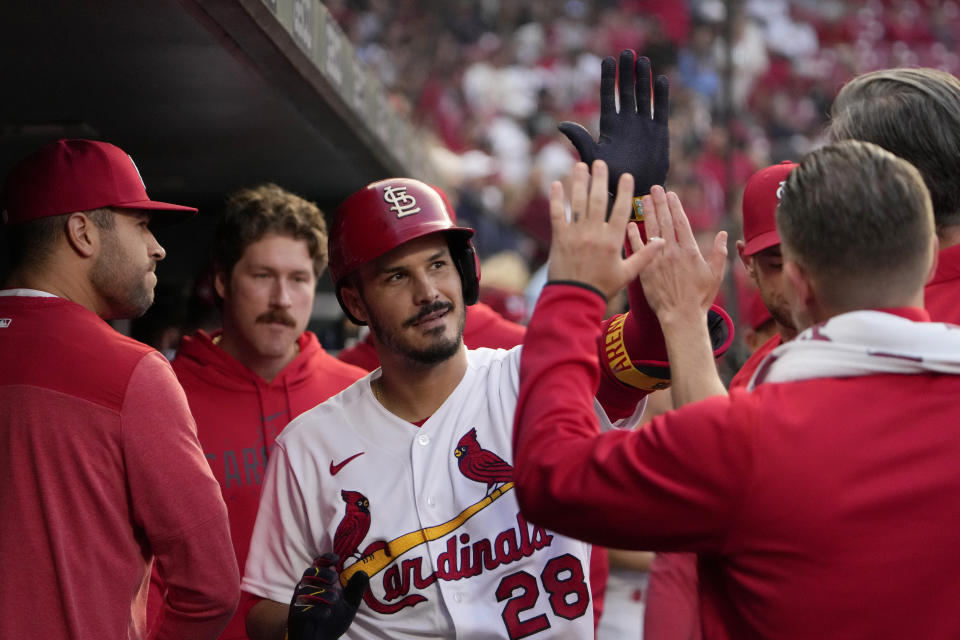 St. Louis Cardinals' Nolan Arenado is congratulated by teammates after hitting a solo home run during the second inning of a baseball game against the Milwaukee Brewers Tuesday, May 16, 2023, in St. Louis. (AP Photo/Jeff Roberson)