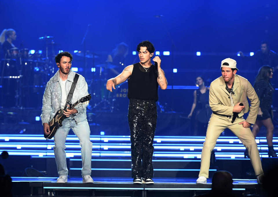 From left, Kevin Jonas, Joe Jonas and Nick Jonas perform onstage in Las Vegas.