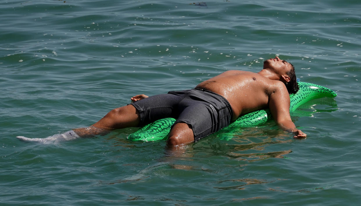 People enjoy the beach in Folkestone, Kent, during the hot weather.Picture date: Monday July 18, 2022. (Photo by Gareth Fuller/PA Images via Getty Images)