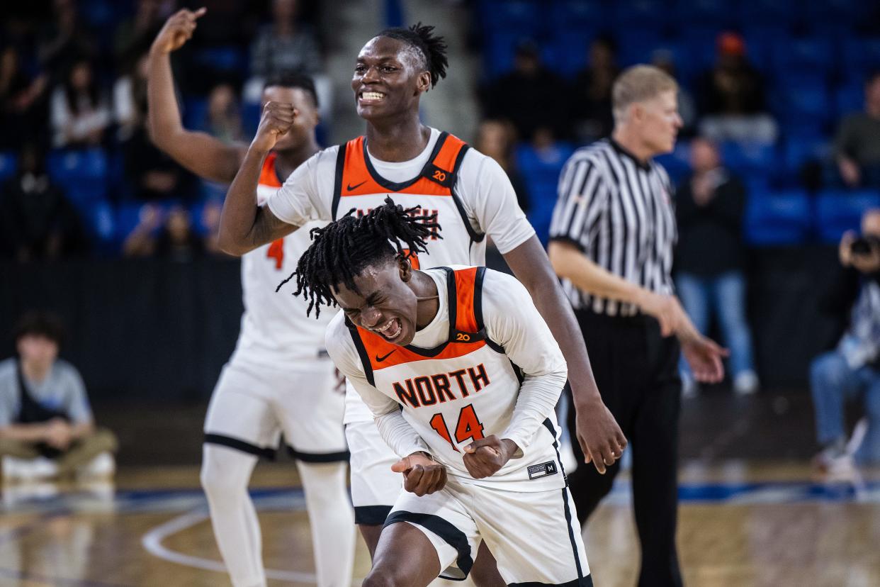 North's Teshaun Steele, front, Joe Okla, center, and Khari Bryan celebrate as Franklin calls a timeout with less than 10 seconds on the clock during the D1 state championship.