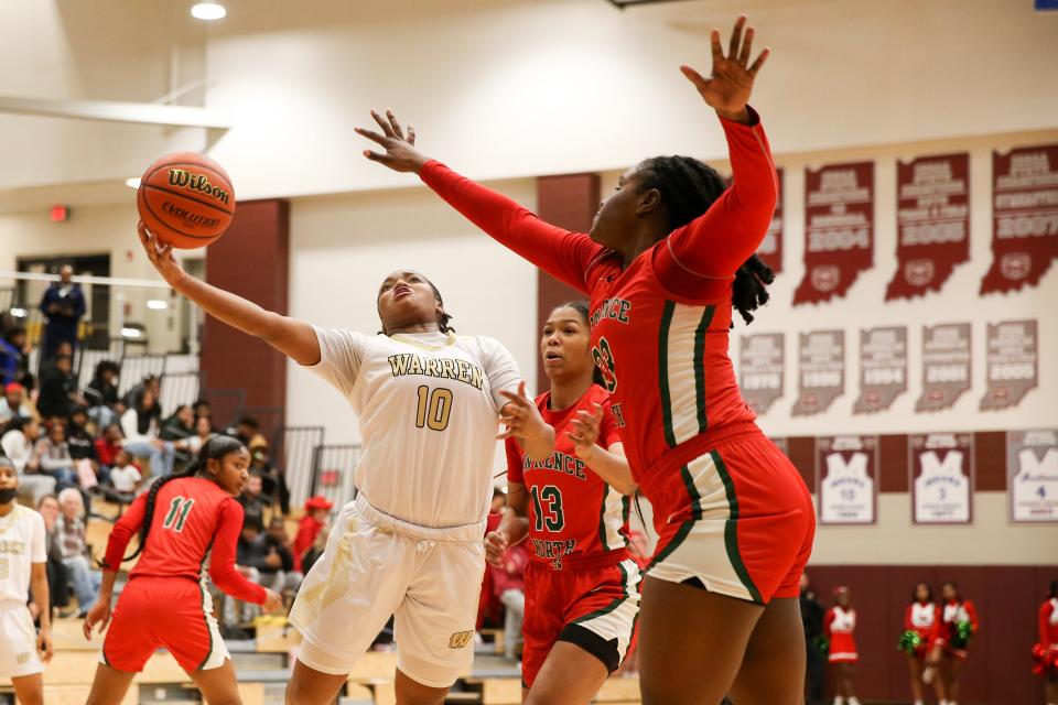 Warren Central Denyha Jacobs (10) tries to shoot sround the defense as the Lawrence North Wildcats take on the Warren Central Warriors during the IHSAA Class 4A Girls Basketball Sectional Championship, February 4, 2023, at Lawrence Central High School.