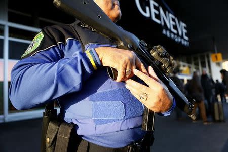 A County of Geneva police officer stands guard outside Cointrin airport in Geneva, Switzerland, December 10, 2015. REUTERS/Pierre Albouy