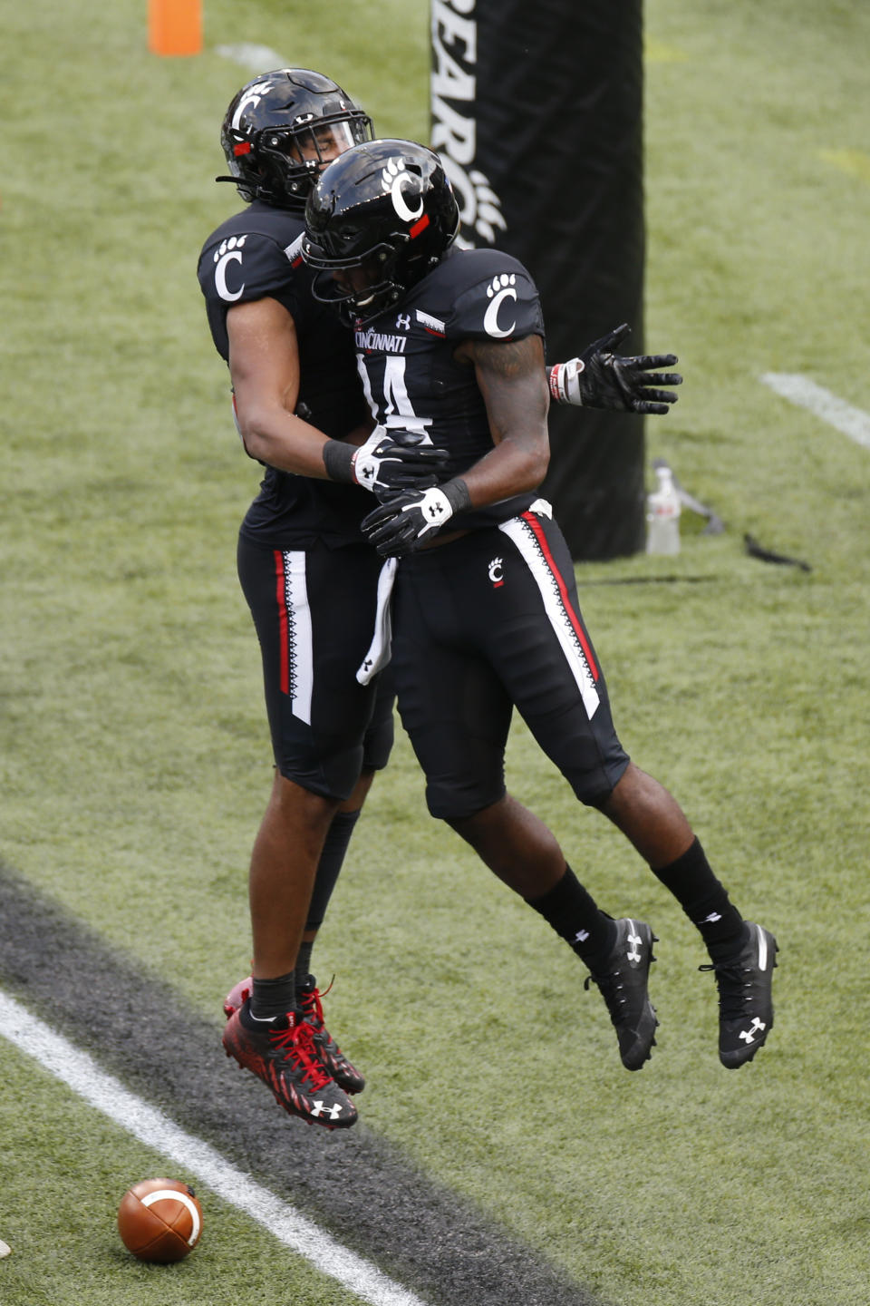 Cincinnati running back Jerome Ford, right, celebrates his touchdown against Army with teammate Leonard Taylor during the second half of an NCAA college football game Saturday, Sept. 26, 2020, in Cincinnati, Ohio. Cincinnati beat Army 24-10. (AP Photo/Jay LaPrete)