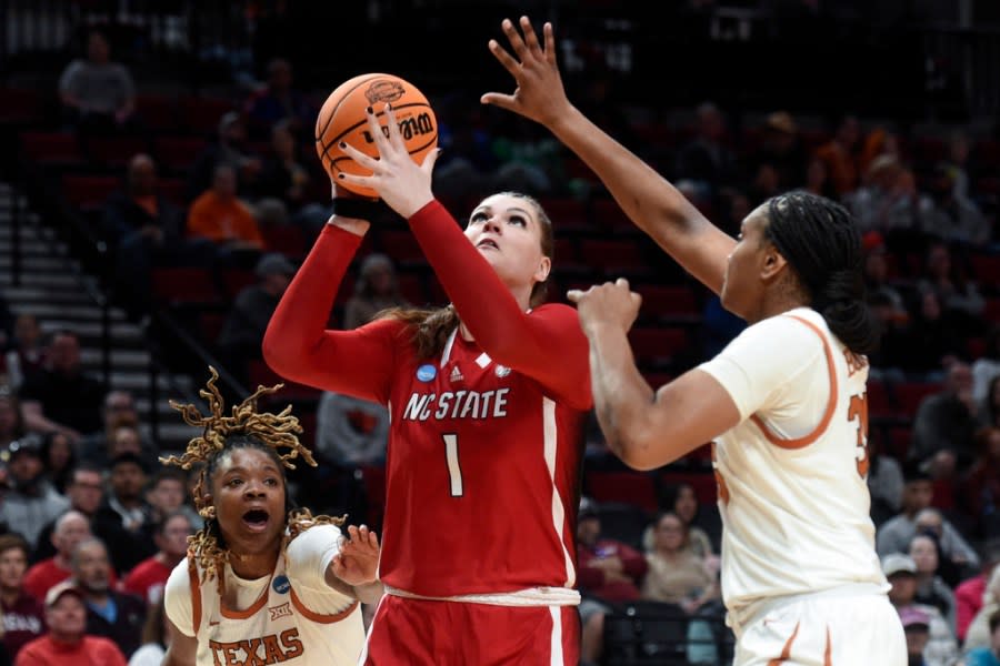 Texas forward Madison Booker, right, and forward DeYona Gaston, left, guard North Carolina State center River Baldwin (1) during the first half of an Elite Eight college basketball game in the women’s NCAA Tournament, Sunday, March 31, 2024, in Portland, Ore. (AP Photo/Steve Dykes)
