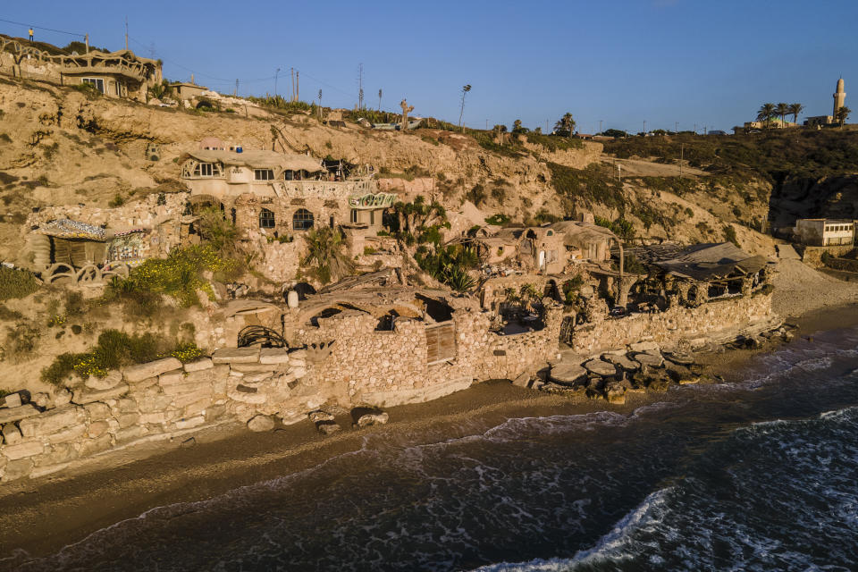 Nissim Kahlon's home, chiseled out of the sandstone cliffs, overlooks the Mediterranean sea in Herzliya, Israel, Wednesday, June 28, 2023. Over half a century, Kahlon has transformed a tiny cave on a Mediterranean beach into an elaborate underground labyrinth filled with chiseled tunnels, detailed mosaic floors and a network of staircases and mysterious chambers. Fifty years after Kahlon moved into the home, Israel's Environmental Protection Agency has served him an eviction notice, claiming the structure threatens Israel's coastline. (AP Photo/Ariel Schalit)