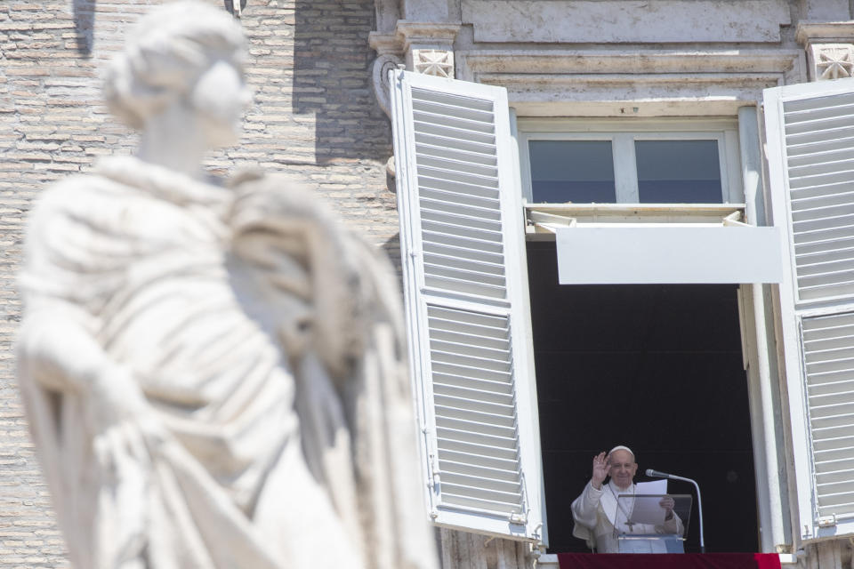 Pope Francis delivers his blessing from his studio window overlooking St. Peter's Square at the Vatican, Sunday, May 31, 2020. Francis celebrated a Pentecost Mass in St. Peter's Basilica on Sunday, albeit without members of the public in attendance. He will then went to his studio window to recite his blessing at noon to the crowds below. The Vatican says police would ensure the faithful gathered in the piazza keep an appropriate distance apart. (AP Photo/Alessandra Tarantino)