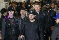 CORRECTS DATE - Los Angeles Dodgers Max Muncy, center, walks with Freddie Freeman, center right, and Jason Heyward, back right, during the baseball team's arrival at Incheon International Airport, Friday, March 15, 2024, in Incheon, South Korea, ahead of the team's baseball series against the San Diego Padres. (AP Photo/Lee Jin-man)