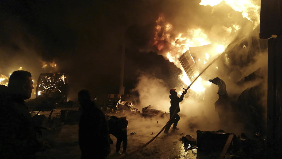 In this photo released by the Syrian official news agency SANA, firefighters work at the scene of missiles attack, at the seaport of the coastal city of Latakia, Syria, Tuesday, Dec. 28, 2021. Israeli missiles fired from the Mediterranean struck the Syrian port of Latakia early Tuesday, igniting a fire in the container terminal, Syrian state media reported, in the second such attack on the vital facility this month. (SANA via AP)