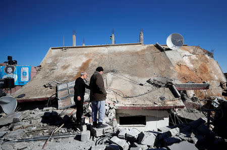 People look at the house of Palestinian family Abu Humaid after it was blown up by the Israeli forces in al-Amari refugee camp in Ramallah, in the Israeli-occupied West Bank December 15, 2018. REUTERS/Mohamad Torokman