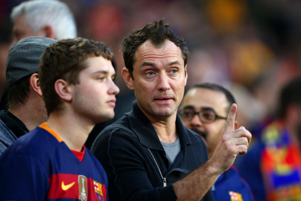 Jude Law takes his seat next to his son Rafferty Law before the start of the La Liga match between FC Barcelona and Real Madrid CF at Camp Nou on April 2, 2016 in Barcelona, Spain.  (Photo by Paul Gilham/Getty Images)