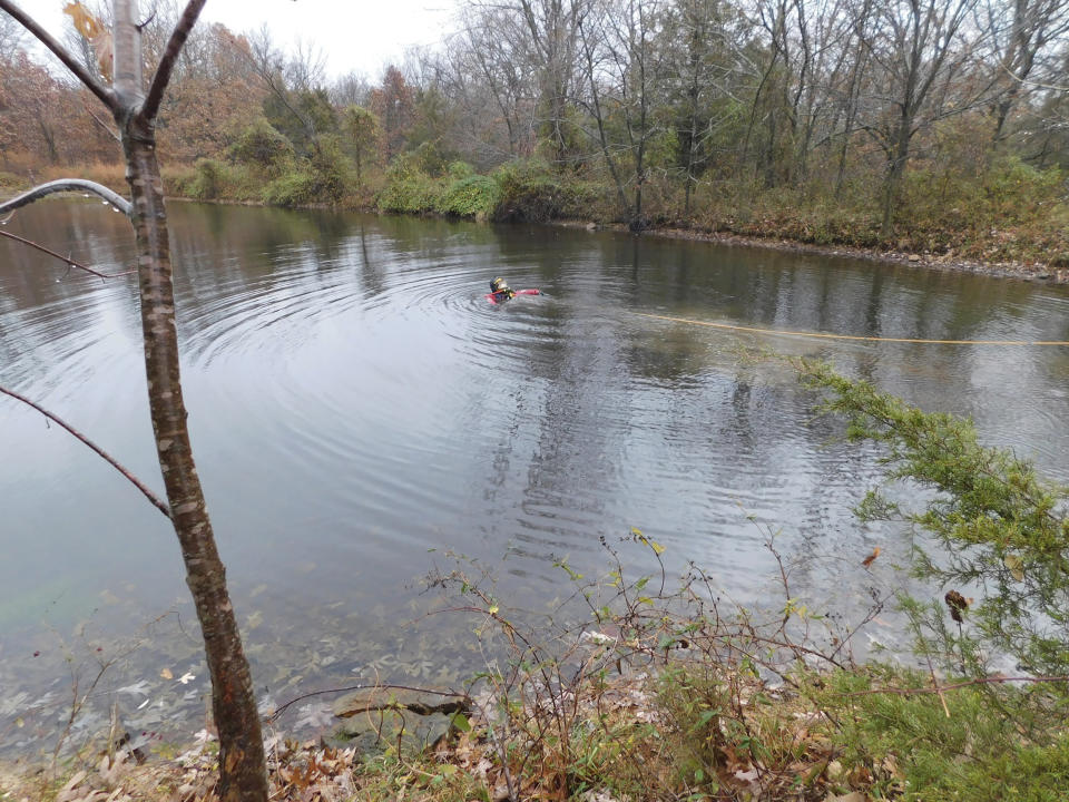 In a photo provided by the Camden County Sheriff's Office, a diver searches the pond where a submerged vehicle was found south of Camdenton, Mo., city limits on Dec. 17, 2023. Camden County deputies are once again investigating the disappearance of Donnie Erwin after dredging up his algae-encrusted vehicle in a tiny roadside drainage pond in December - almost exactly a decade after the 59-year-old went missing. (Detective Sgt Jeremiah Burnett/Camden County Sheriff’s Office via AP)