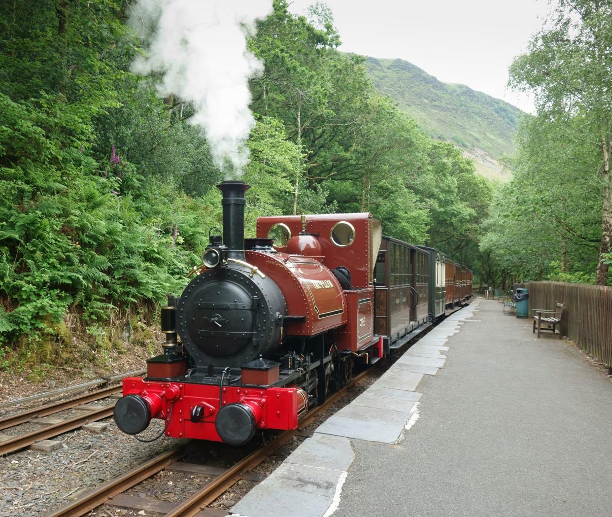 Nant Gwernol, Wales, UK - June 25th, 2015: Steam train at platform on the The Talyllyn Railway, a narrow-gauge preserved railway in Wales running  from Tywyn on the Mid-Wales coast to Nant Gwernol near the village of Abergynolwyn.