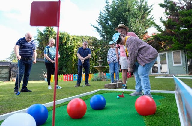 People trying out a crazy golf course