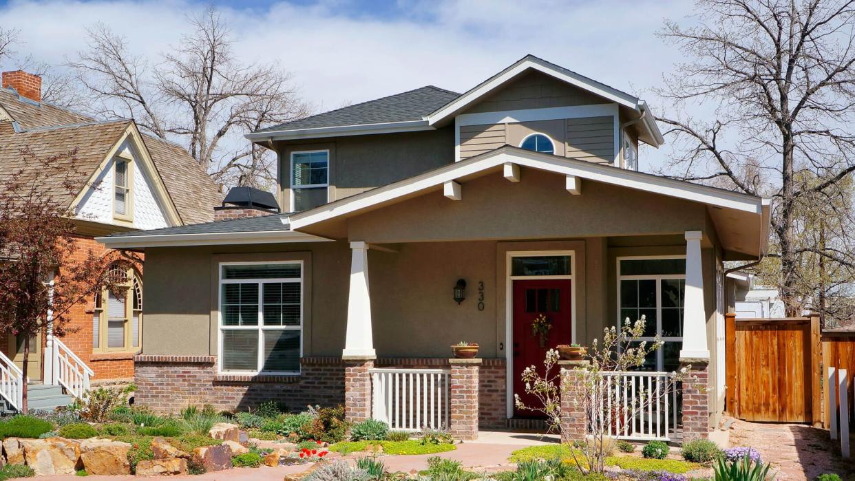 Fort Collins, Colorado, USA - April 26, 2014: Neighborhood with historic homes and beautiful landscaping in the Old Town of Fort Collins, Colorado.