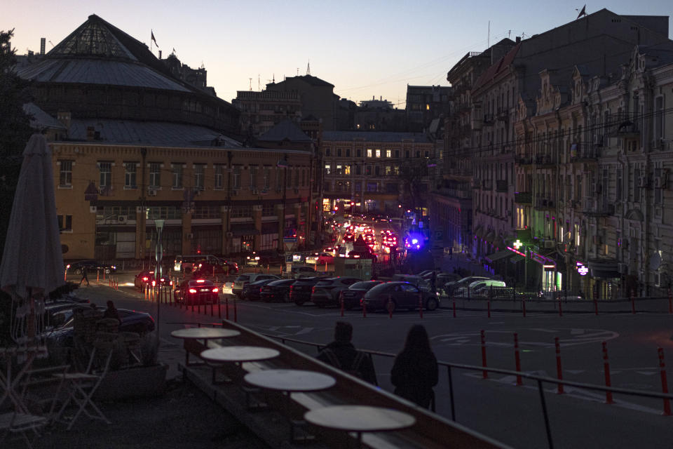 Cars move in a street during a blackout in Kyiv, Ukraine, Wednesday, Nov. 9, 2022. (AP Photo/Andrew Kravchenko)