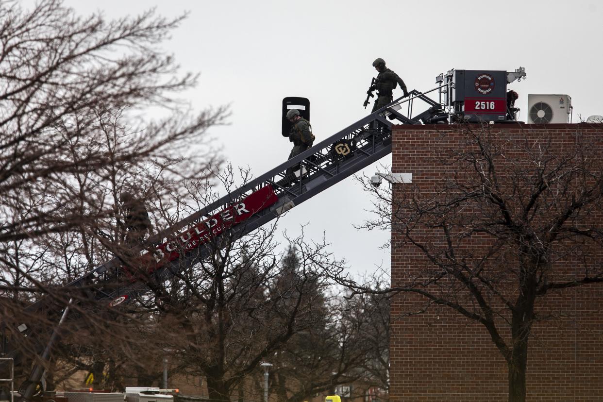 SWAT teams descend from the roof on a fire ladder after a gunman opened fire at a King Soopers grocery store on March 22, 2021, in Boulder, Colorado. Ten people, including a police officer, were killed in the attack.