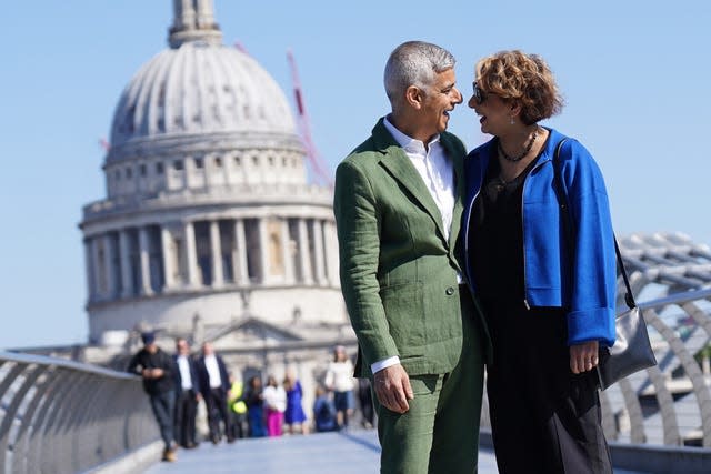 Sadiq Khan and his wife Saadiya pose for photographers on the Millennium Bridge 