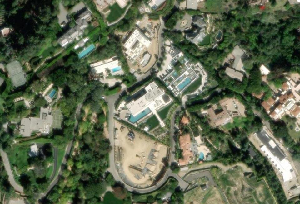 An aerial photo of Beyoncé and Jay-Z's Bel Air mansion, showing several houses from above with swimming pools, separated by winding roads and greenery