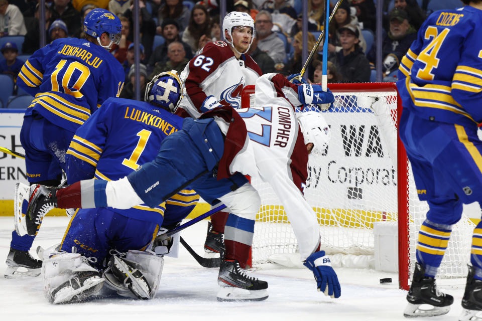 Colorado Avalanche left wing J.T. Compher (37) celebrates a goal by left wing Artturi Lehkonen (62) during the second period of the team's NHL hockey game against the Buffalo Sabres, Thursday, Dec. 1, 2022, in Buffalo, N.Y. (AP Photo/Jeffrey T. Barnes)