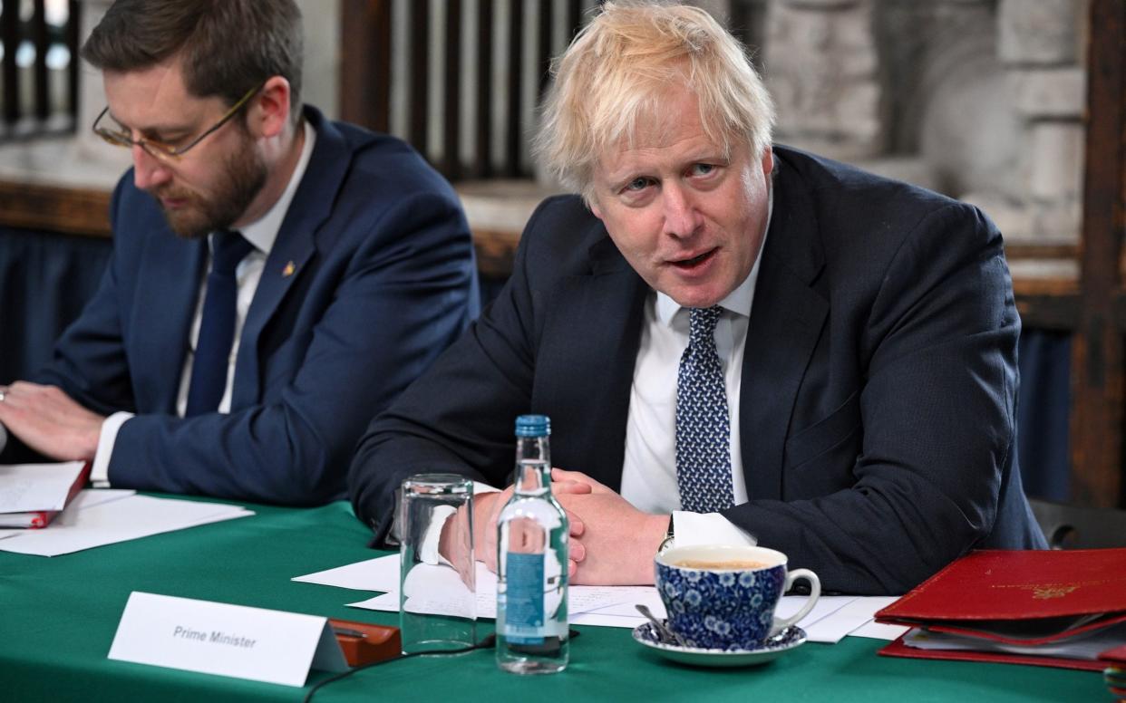 Prime Minister Boris Johnson and Cabinet Secretary Simon Case sit together at a Cabinet meeting - Getty