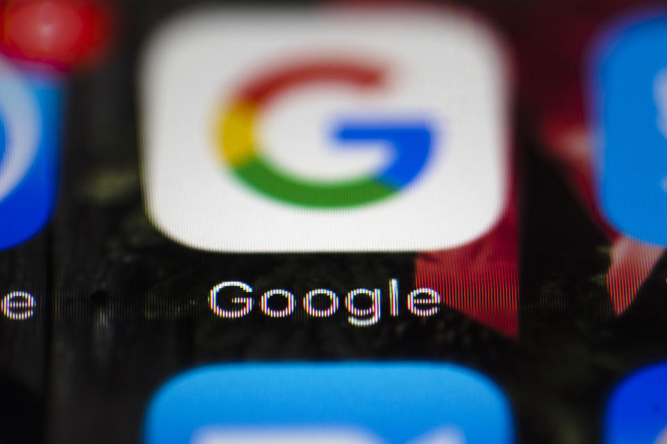 FILE- This April 26, 2017, file photo shows a Google icon on a mobile phone in Philadelphia. New Mexico is suing Google, Twitter and other companies that develop and market mobile gaming apps for children, saying the apps violate state and federal laws by collecting personal information that could compromise privacy. The lawsuit filed in federal court late Tuesday, Sept. 11, 2018, comes as data-sharing concerns persist among users. (AP Photo/Matt Rourke, File)
