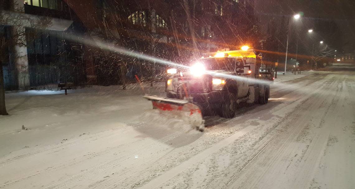 A city plow clears snow from a road during a storm that arrived Monday, Dec. 19, in Bellingham.