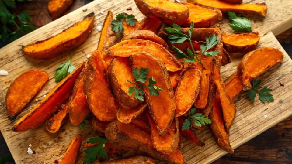 Sweet potato fries on a wood board