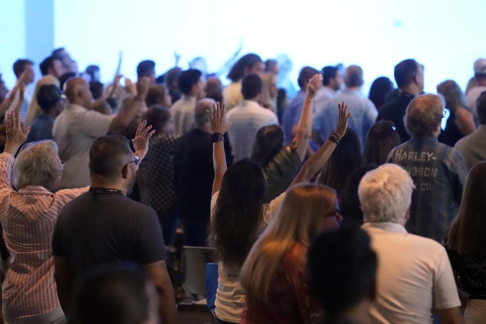 Members of the Trabuco Caynon community join in a prayer vigil to help families cope with the Cook's Corner shooting tragedy at the Saddleback Church in Lake Forest, Calif., Friday, Aug. 25, 2023. (AP Photo/Damian Dovarganes)